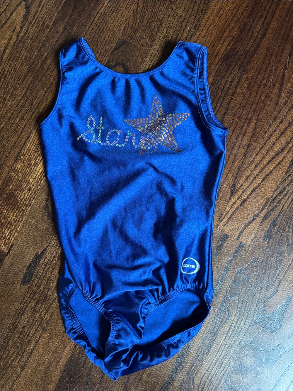 Zone blue adult small leotard. The word “star” in cursive sequins. Excellent!